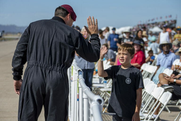 The U.S. Army Parachute Team high fives members of the crowd at the 2022 Marine Corps Air Station Miramar Air Show at MCAS Miramar, California, Sept. 24, 2022. Nicknamed the Golden Knights in 1962, “Golden” signifies the gold medals the team won in international competitions, and “Knights” alludes to the team’s ambition to conquer the skies. The Golden Knights perform in more than 100 events per year.  The theme for the 2022 MCAS Miramar Air Show, “Marines Fight, Evolve and Win,” reflects the Marine Corps’ ongoing modernization efforts to prepare for future conflicts. (U.S. Marine Corps photo by Lance Cpl. Zachary Larsen)